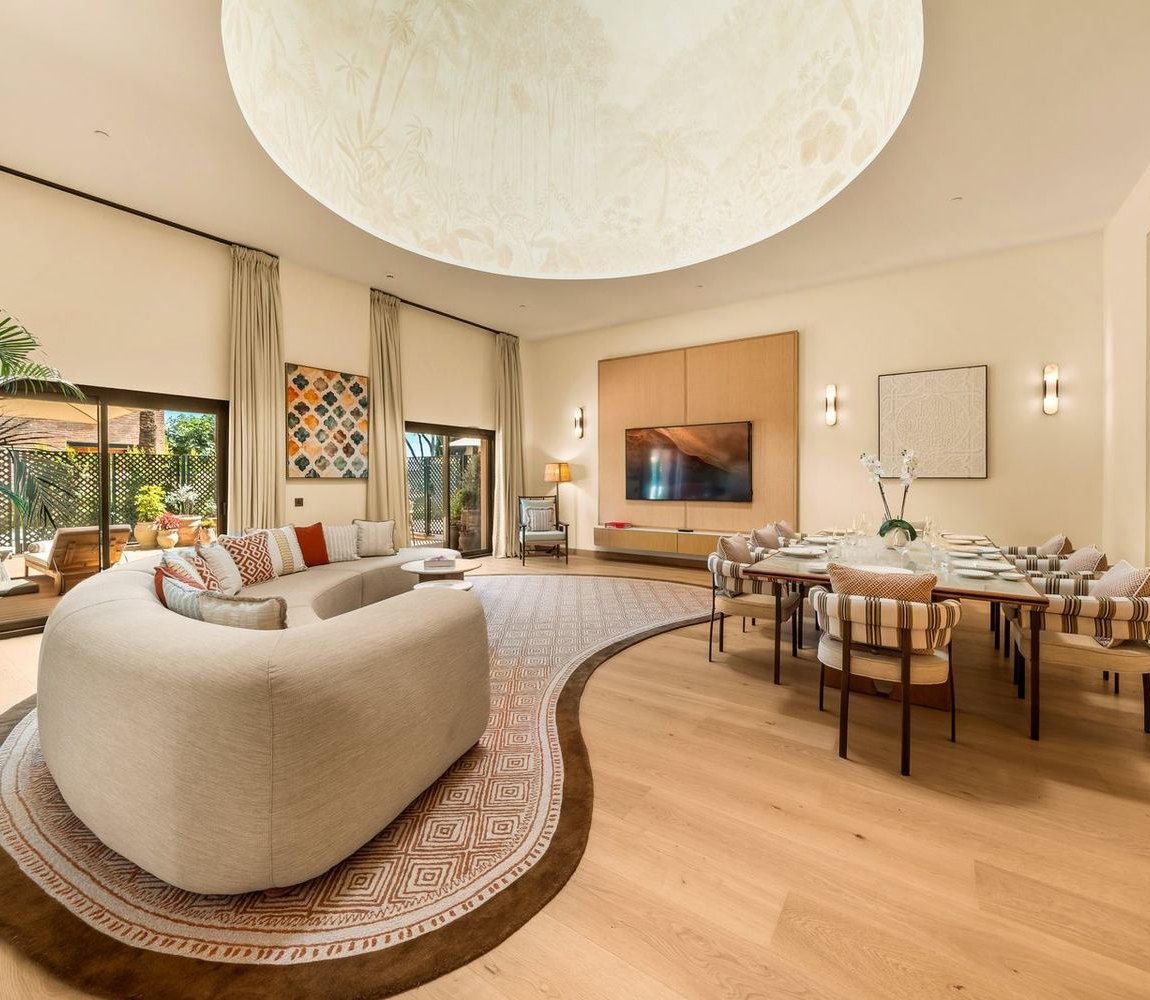 The Dome Suite, a round cream sofa under a domed ceiling light, garden doors behind.